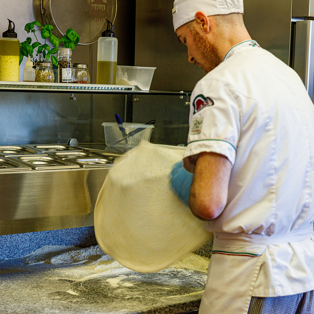 Chef spinning pizza dough