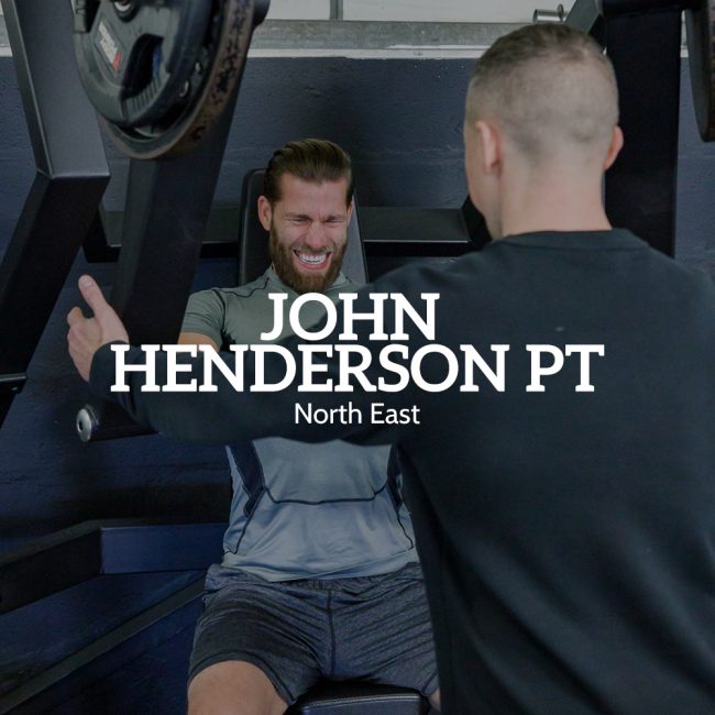John Henderson helps a gymgoer with weights training