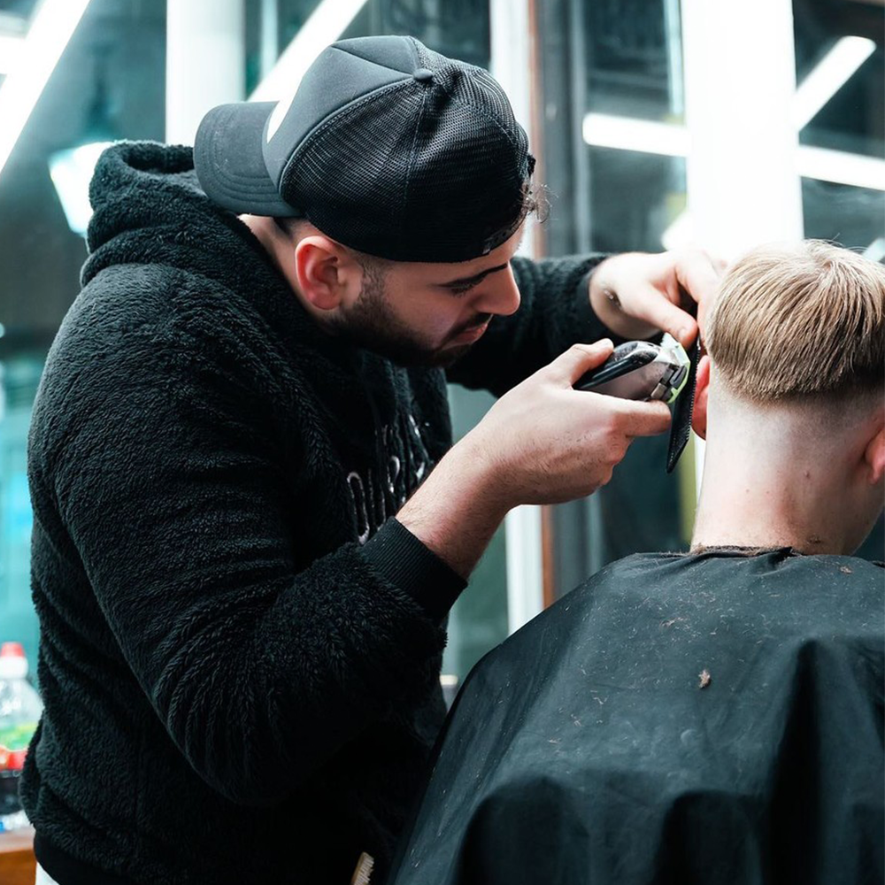 Man receiving haircut at Newcastle City Centre barbers